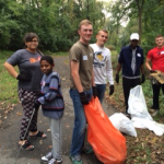 Students participate in service learning project cleaning trail