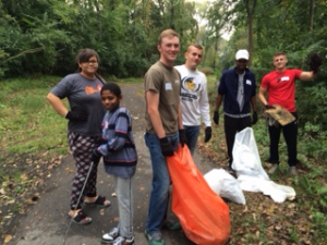 Students participate in service learning project cleaning trail