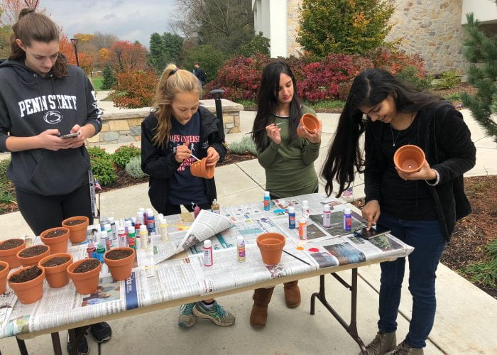 Students for sustainability paint clay pots
