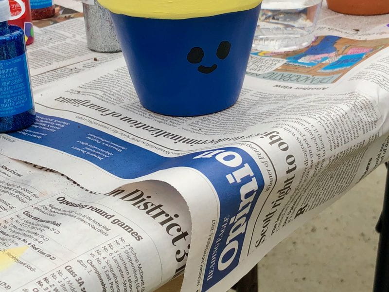 painted clay pot on newspaper